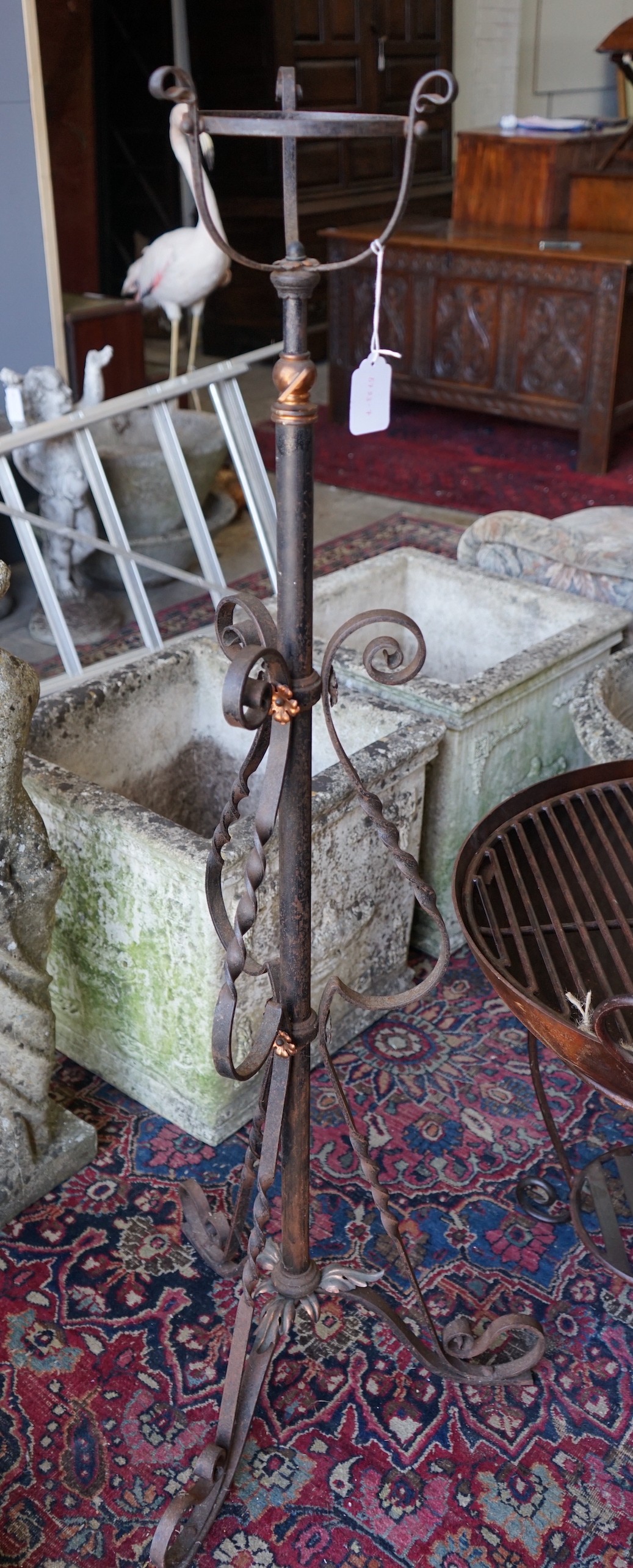 An early 20th century copper mounted wrought iron telescopic oil lamp standard
